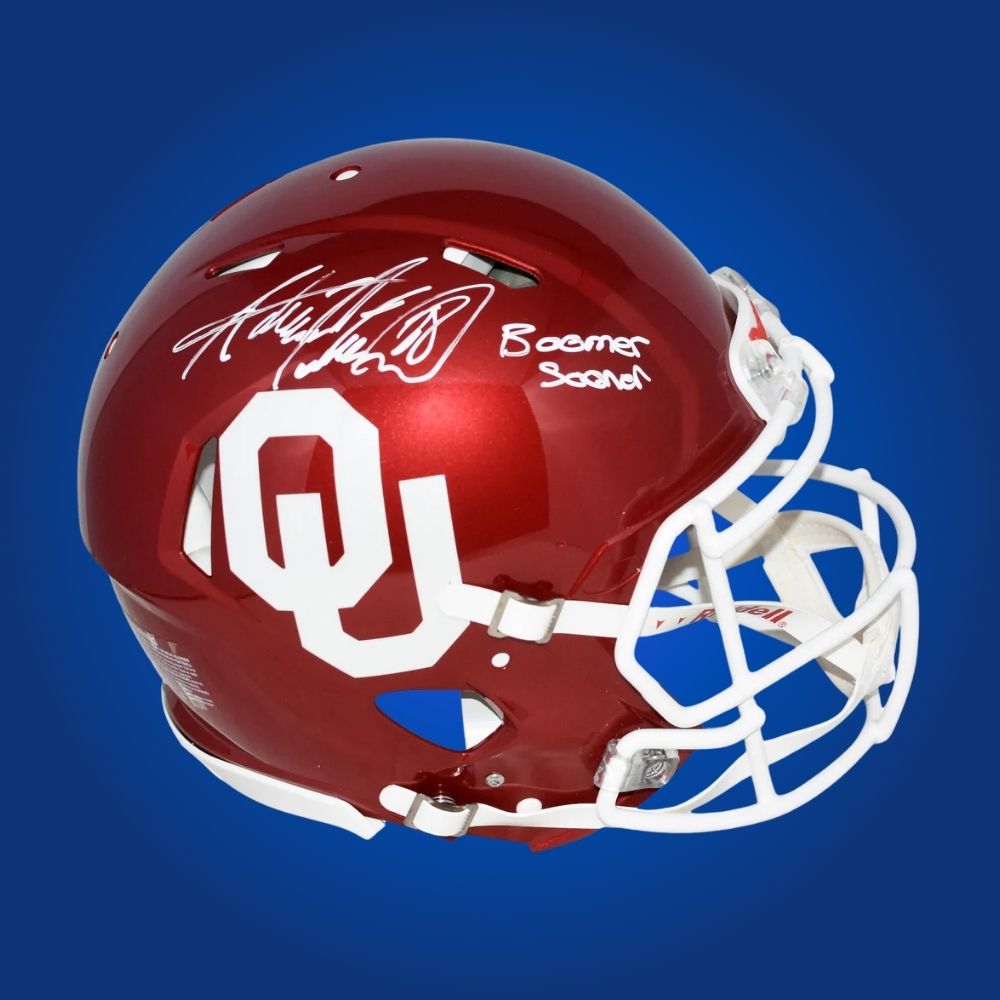 Autographed Oklahoma Sooners full size Authentic Helmet signed by Adrian Peterson, displayed on a white background. SportsMarkets memorabilia product photo.