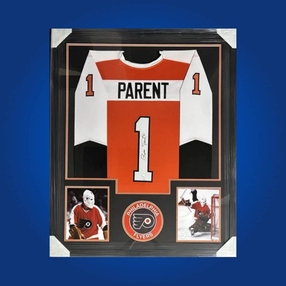 Bernie Parent’s signed full framed Philadelphia Flyers orange jersey is a prime collectible, honoring the Hall of Fame goaltender’s legacy and championship pedigree.