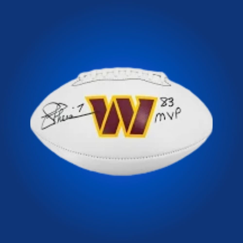 Joe Theismann signed Commanders logo football, displaying quarterback’s autograph and Washington logo.