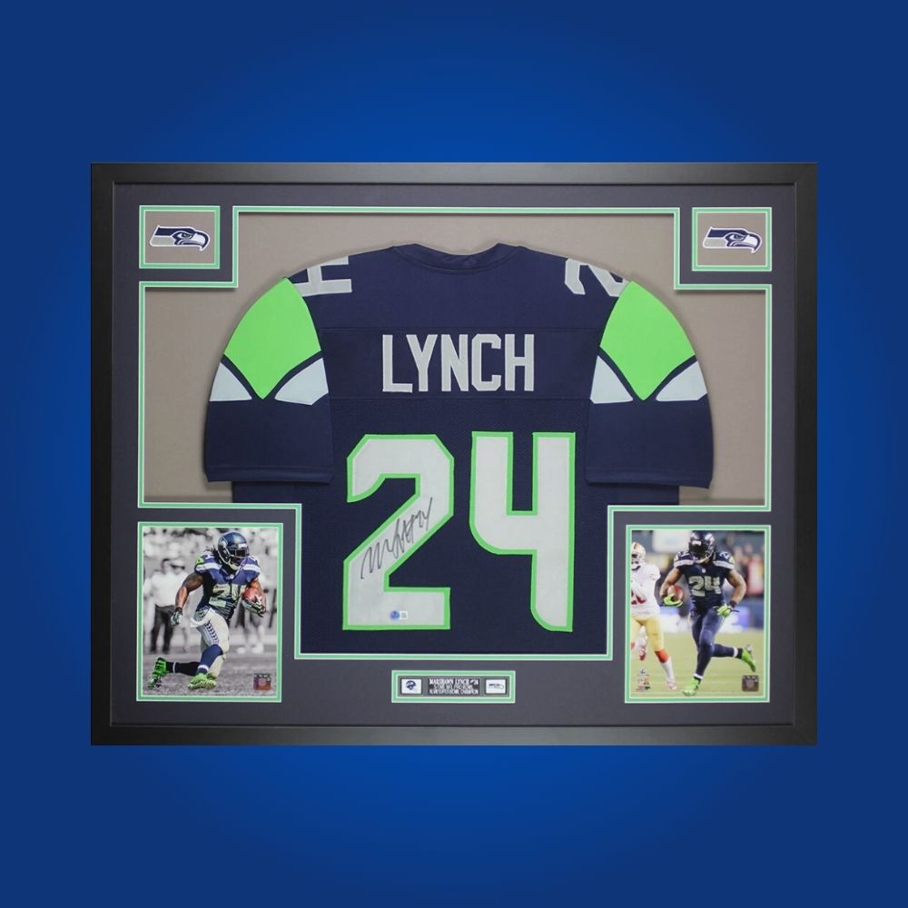 Framed Seattle Seahawks jersey signed by Marshawn Lynch with action photos and Certificate of Authenticity.