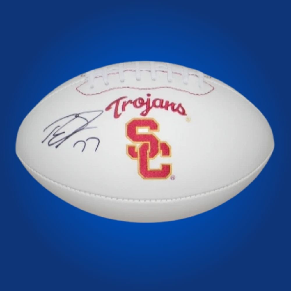 Autographed full size replica football by Tyron Smith, featuring USC Trojans white logo. Certified authentic, a prime collectible for Trojans fans and memorabilia collectors. Certificate of Authenticity included. Ball details may vary for catalog consistency.