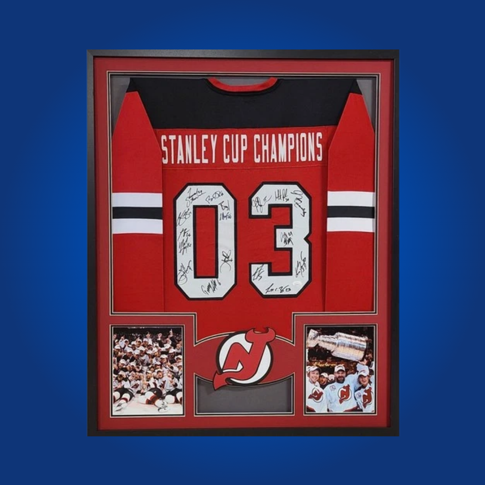The 2003 Stanley Cup Champs full framed New Jersey Devils red jersey, signed by the championship team, is a rare and historic piece for collectors, celebrating New Jersey’s unforgettable title run.