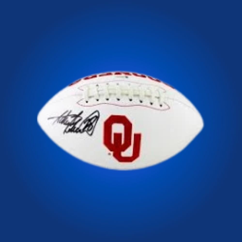 Adrian Peterson autographed Oklahoma Sooners white logo football, prized memorabilia for Sooners fans and collectors.