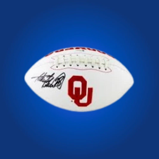 Adrian Peterson autographed Oklahoma Sooners white logo football, prized memorabilia for Sooners fans and collectors.