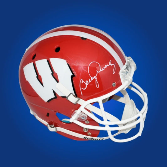 Autographed full size Authentic Helmet by Barry Alvarez, iconic Wisconsin Badgers coach, showcased on a crisp white background for a premium presentation. Perfect for collectors and Wisconsin supporters. SportsMarkets product photo.