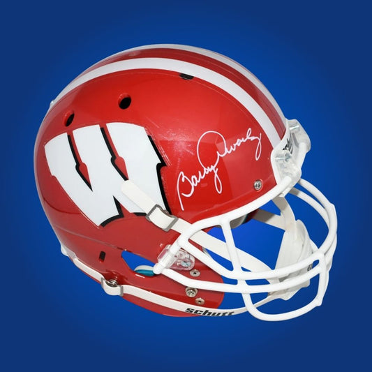 Autographed full size replica helmet by Barry Alvarez, iconic Wisconsin Badgers coach, showcased on a crisp white background for a premium presentation. Perfect for collectors and Wisconsin supporters. SportsMarkets product photo.