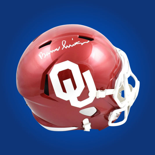 Autographed Oklahoma Sooners full size replica helmet signed by Barry Switzer, featured on a white background. SportsMarkets collectible product image.