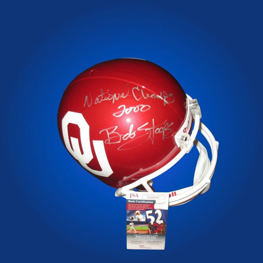 Autographed Oklahoma Sooners full size Authentic Helmet signed by Bob Stoops, displayed on a clean white background. SportsMarkets collectible memorabilia image.