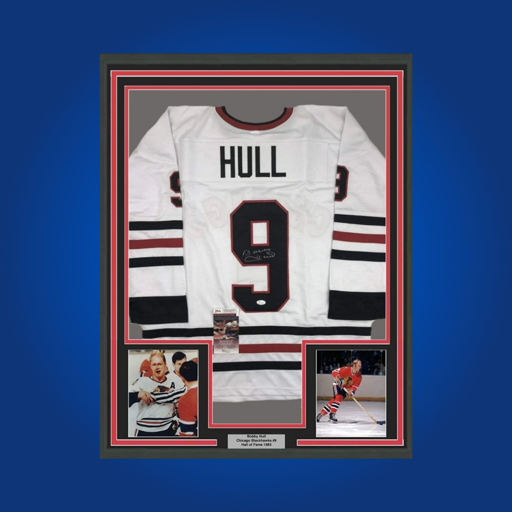 Bobby Hull’s hand-signed full framed Chicago Blackhawks white jersey is a classic collectible, perfect for fans celebrating the legacy of the “Golden Jet” and Blackhawks legend.