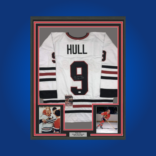 Bobby Hull’s hand-signed full framed Chicago Blackhawks white jersey is a classic collectible, perfect for fans celebrating the legacy of the “Golden Jet” and Blackhawks legend.