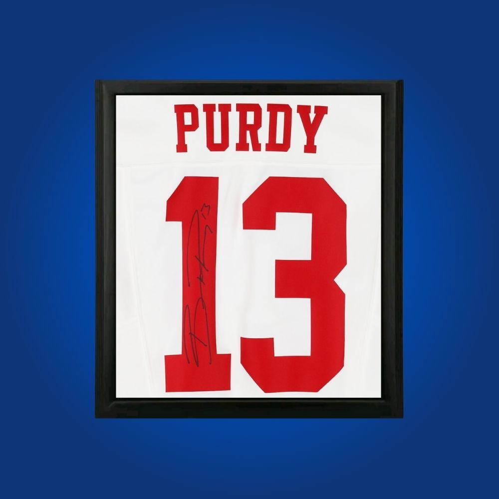 Brock Purdy hand-signed framed San Francisco 49ers jersey, showcasing signature and official team graphics. A unique collectible for 49ers fans and Purdy memorabilia collectors. Includes Certificate of Authenticity. Images may differ for catalog uniformity.