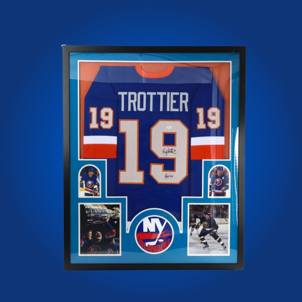 Bryan Trottier’s full framed New York Islanders blue jersey, personally signed, commemorates the Hall of Famer’s championship contributions and is a cornerstone piece for Islanders fans.