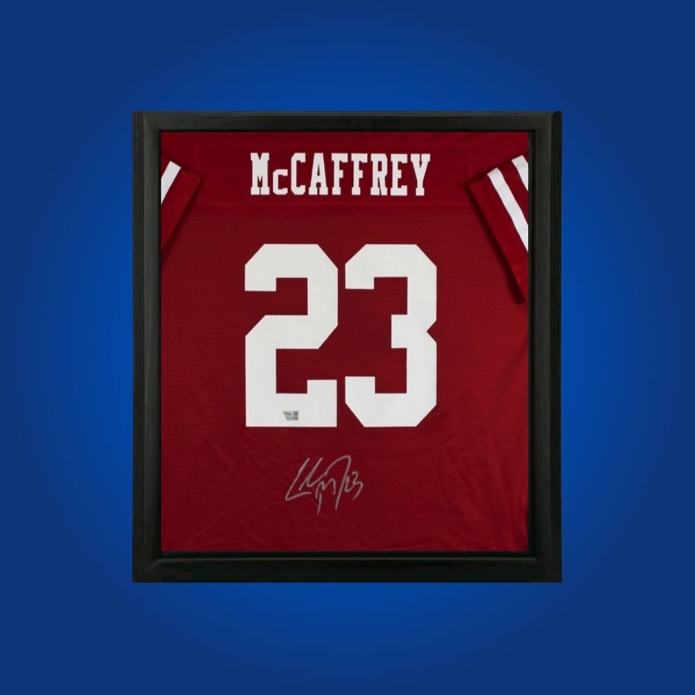 Christian McCaffrey hand-signed red framed San Francisco 49ers jersey, showcasing signature and official team graphics. A unique collectible for 49ers fans and McCaffrey memorabilia collectors. Includes Certificate of Authenticity. Images may differ for catalog uniformity.