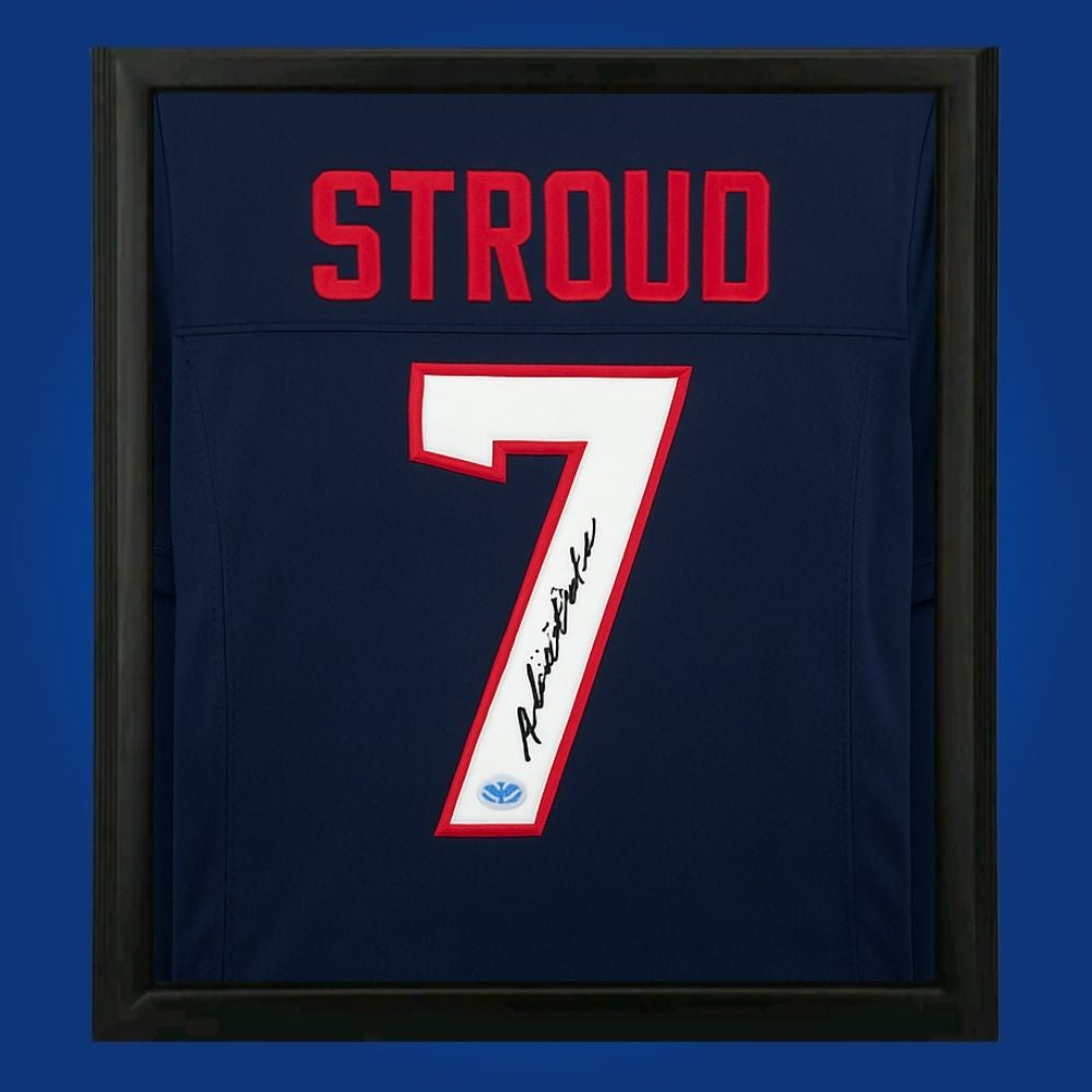 CJ Stroud hand-signed Houston Texans framed jersey, showcasing signature and official team graphics. A unique collectible for Texans fans and Stroud memorabilia collectors. Includes Certificate of Authenticity. Images may differ for catalog uniformity.