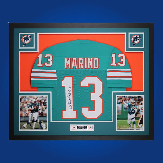 Autographed Miami Dolphins custom jersey by Dan Marino with Certificate of Authenticity.