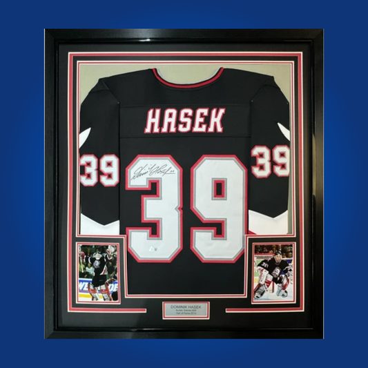 Dominik Hasek’s signature on this full framed Buffalo Sabres black jersey makes it a must-have for any hockey memorabilia collection, honoring one of the greatest goaltenders in NHL history.