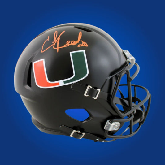 Autographed Miami Hurricanes full size replica helmet signed by Ed Reed, displayed on a white background. SportsMarkets product image.