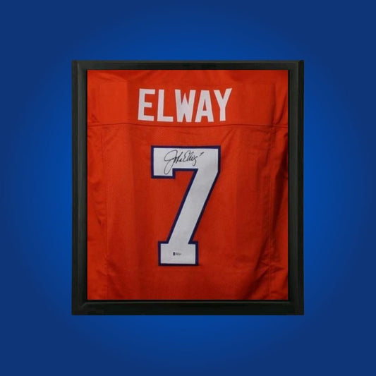 John Elway hand-signed orange framed Denver Broncos jersey, showcasing signature and official team graphics. A unique collectible for Broncos fans and Elway memorabilia collectors. Includes Certificate of Authenticity. Images may differ for catalog uniformity.