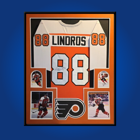 Eric Lindros’ signed full framed Philadelphia Flyers white jersey is an iconic collectible, commemorating the legendary power forward’s impact and his era-defining presence in Philadelphia.