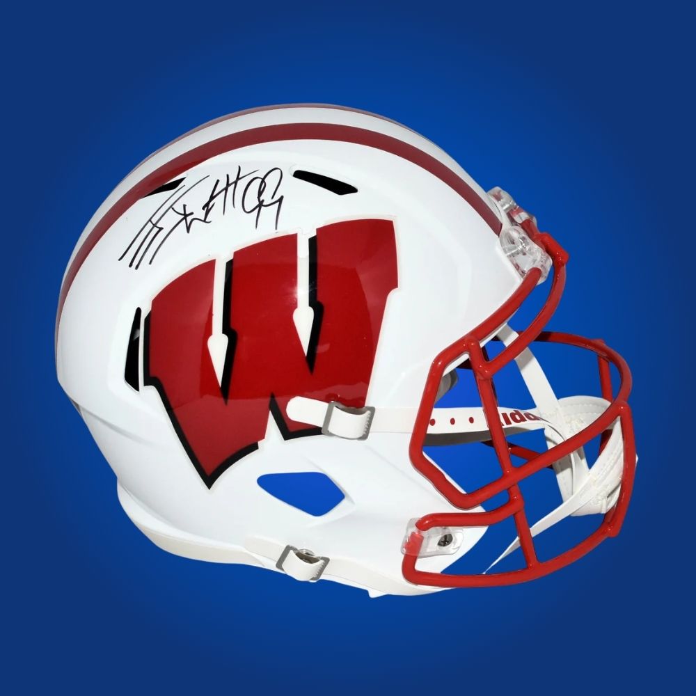 Autographed full size replica helmet by J.J. Watt, legendary Wisconsin Badgers and NFL superstar, highlighted against a professional white backdrop. Perfect for dedicated collectors and Wisconsin fans. SportsMarkets product image.