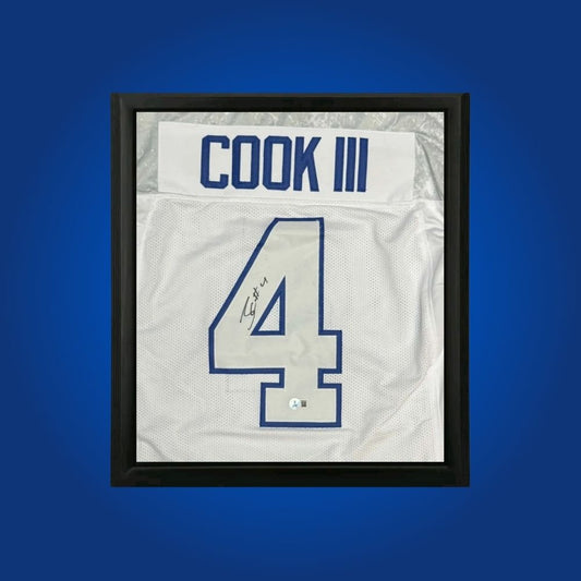 James Cook hand-signed whiteout framed Buffalo Bills jersey, showcasing signature and official team graphics. A unique collectible for Bills fans and Cook memorabilia collectors. Includes Certificate of Authenticity. Images may differ for catalog uniformity.