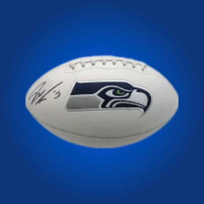 Jaxon Smith-Njigba signed Seahawks logo football, showcasing rookie wide receiver’s autograph and team logo.