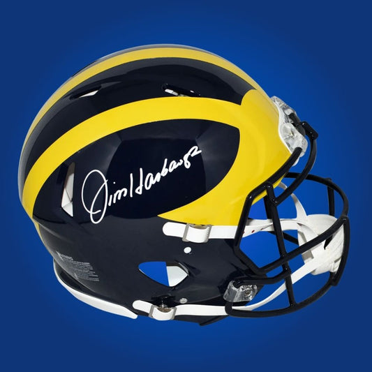 Autographed Michigan Wolverines full size Authentic Helmet signed by Jim Harbaugh, shown on a white background. SportsMarkets collectible product photo.