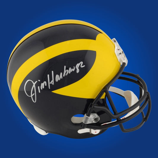 Autographed Michigan Wolverines full size replica helmet signed by Jim Harbaugh, shown on a white background. SportsMarkets collectible product photo.