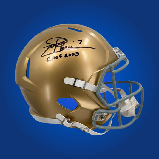 Autographed Notre Dame Fighting Irish full size replica helmet signed by Joe Theismann, displayed on a white display background. SportsMarkets memorabilia image.