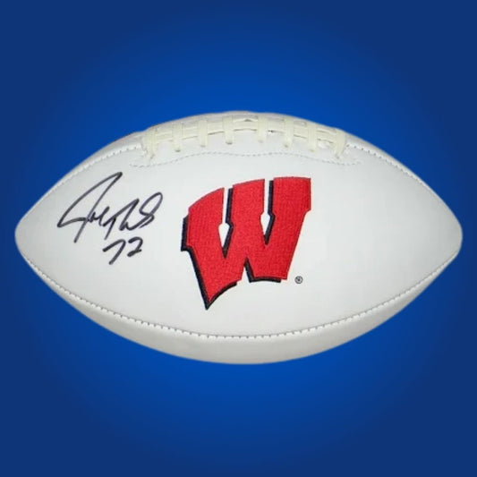 Autographed full size replica football by Joe Thomas, featuring Wisconsin Badgers white logo. Certified authentic, a premium collectible for Wisconsin fans and memorabilia collectors. Certificate of Authenticity included. Ball details may vary for catalog consistency.
