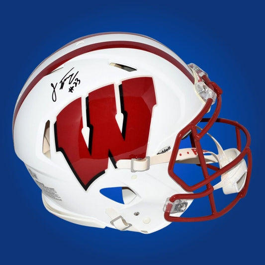 Autographed full size Authentic Helmet by Jonathan Taylor, record-setting Wisconsin Badgers running back, displayed on a pristine white background for catalog clarity. A must-have for fans and memorabilia collectors. SportsMarkets product image.