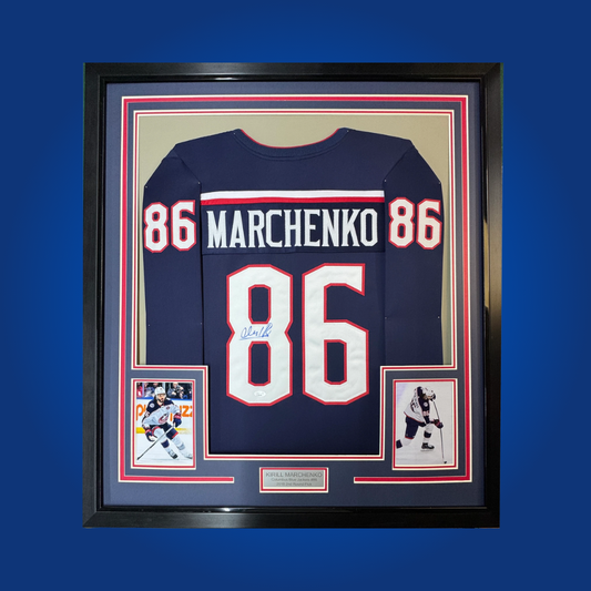 Kirill Marchenko’s autographed full framed Columbus Blue Jackets navy blue jersey is a must-have for fans and collectors of emerging NHL talent, showcasing his promise and skill.