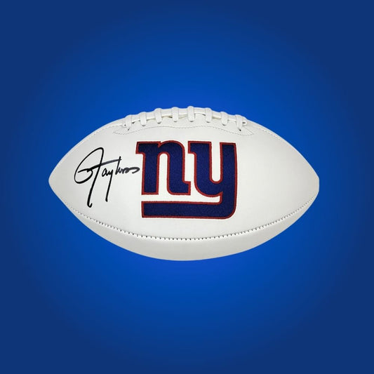 New York Giants logo football signed by Lawrence Taylor, showing player signature and team branding.