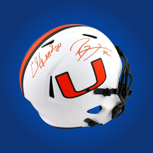 Lewis and Reed hand-signed Miami Hurricanes whiteout replica helmet, showcasing signatures and official team graphics. A unique collectible for Miami fans and Hurricanes memorabilia collectors. Includes Certificate of Authenticity. Images may differ for catalog uniformity.