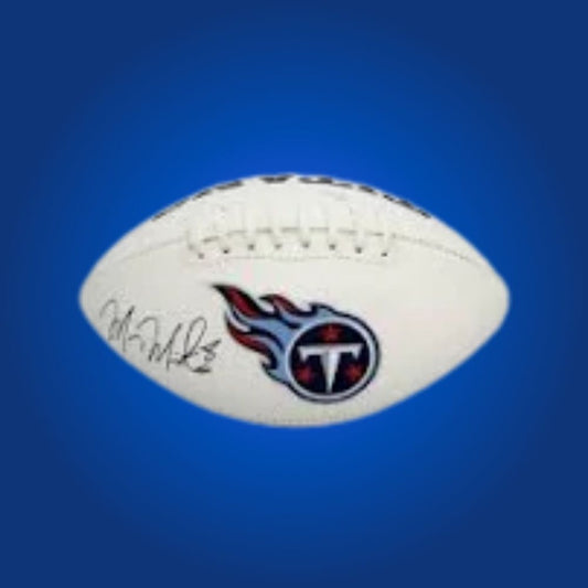 Marcus Mariota signed Titans logo football, displaying Heisman winner’s signature and Tennessee logo.