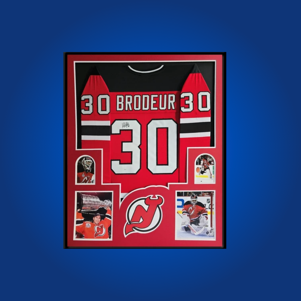 Martin Brodeur’s full framed New Jersey Devils red jersey, personally autographed, is an iconic collectible for hockey fans, honoring one of the greatest goaltenders in league history.