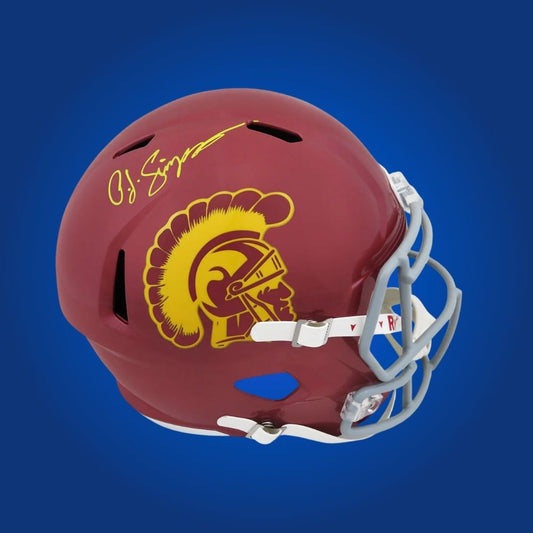 Autographed full size replica helmet by O.J. Simpson, legendary USC Trojans running back and Heisman Trophy winner, showcased on a crisp white background for a distinctive memorabilia presentation. A rare collectible for fans. SportsMarkets product photo.