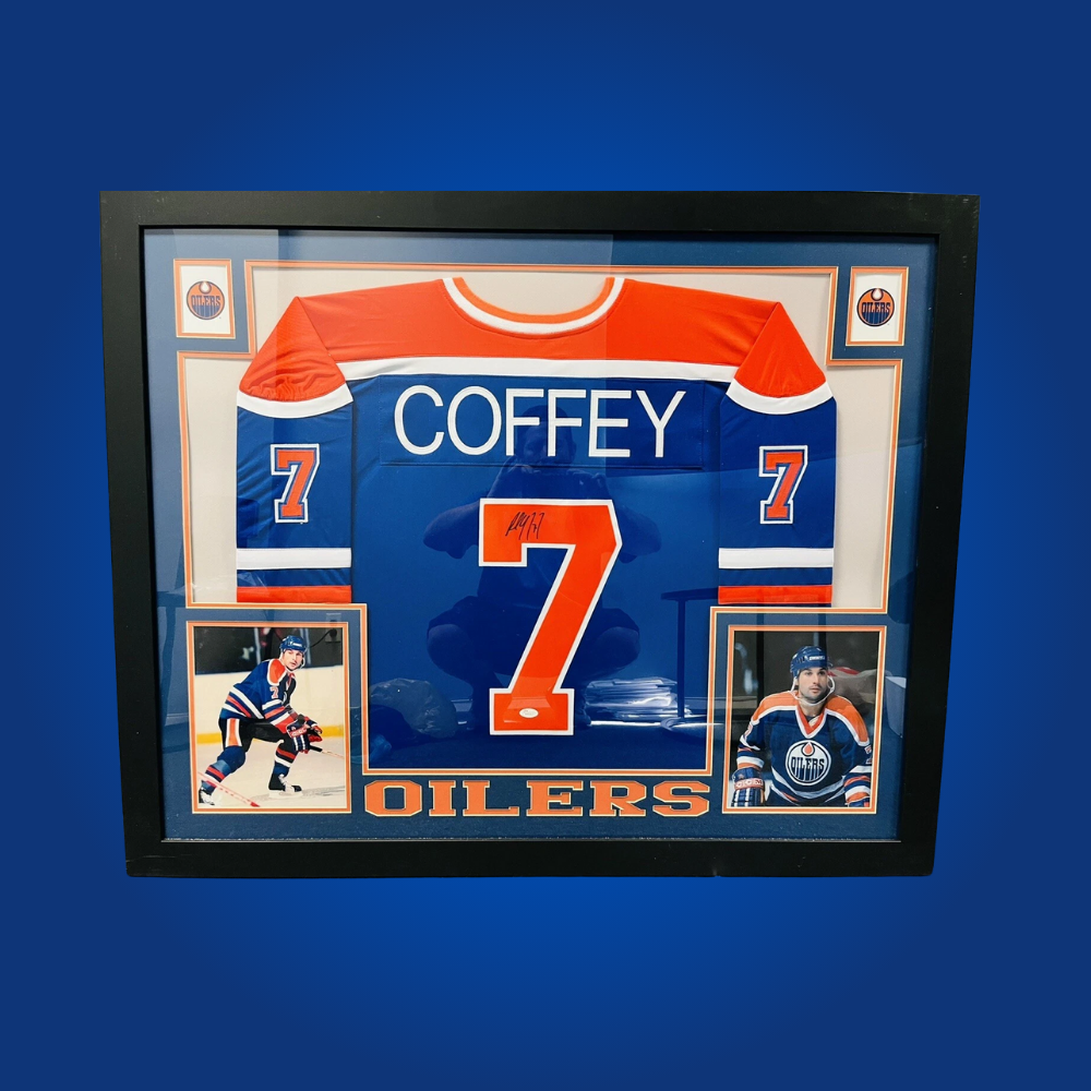Paul Coffey’s autographed full framed Edmonton Oilers blue jersey is a must-have collectible, celebrating the achievements of a dynamic defenseman and multiple Stanley Cup champion.