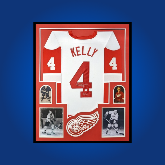 Red Kelly’s full framed Detroit Red Wings white jersey, signed and authenticated, offers collectors a piece of hockey history from one of the most versatile and decorated players in NHL lore.