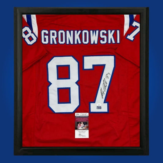 Rob Gronkowski hand-signed New England Patriots framed jersey, showcasing signature and official team graphics. A unique collectible for Patriots fans and Gronkowski memorabilia collectors. Includes Certificate of Authenticity. Images may differ for catalog uniformity.