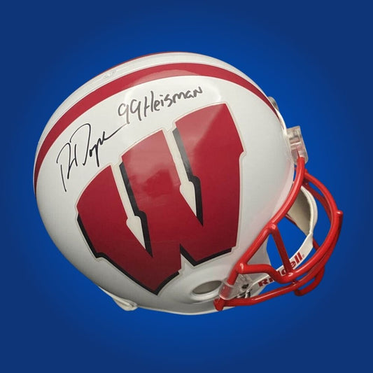 Autographed full size Authentic Helmet by Ron Dayne, celebrated Wisconsin Badgers running back and Heisman winner, presented on a crisp white background. Excellent addition for collectors and Badgers supporters. SportsMarkets memorabilia photo.
