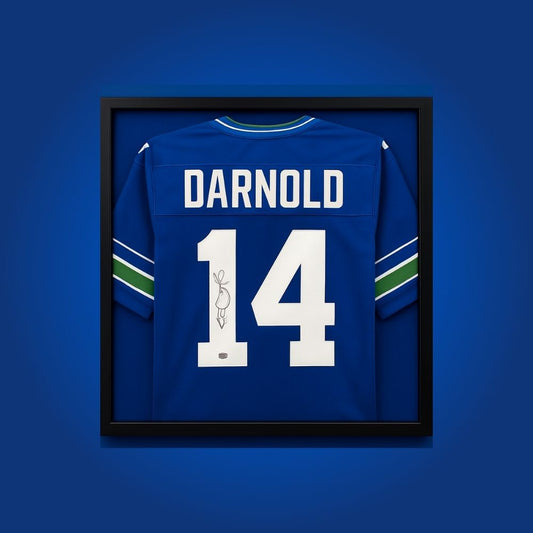 Sam Darnold hand-signed framed Seattle Seahawks jersey, showcasing signature and official team graphics. A unique collectible for Seahawks fans and Darnold memorabilia collectors. Includes Certificate of Authenticity. Images may differ for catalog uniformity.