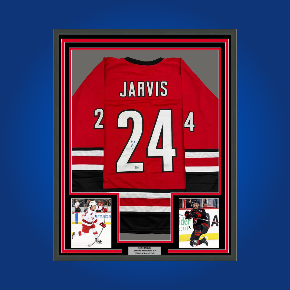 Seth Jarvis’ autographed full framed red Carolina Hurricanes jersey is a vibrant collectible, ideal for fans looking to celebrate the achievements of an emerging NHL player.