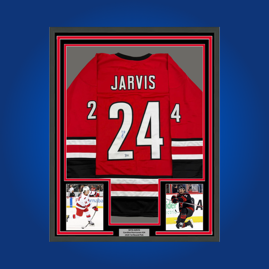 Seth Jarvis’ autographed full framed red Carolina Hurricanes jersey is a vibrant collectible, ideal for fans looking to celebrate the achievements of an emerging NHL player.