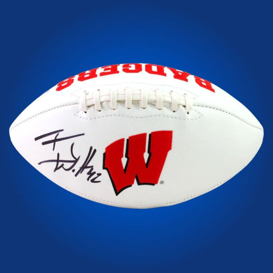 Autographed full size replica football by TJ Watt, featuring Wisconsin Badgers white logo. Certified authentic, a must-have item for Badgers fans and sports memorabilia collectors. Certificate of Authenticity included. Ball details may differ for catalog consistency.