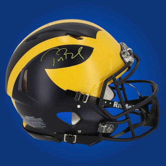 Autographed Michigan Wolverines full size Authentic Helmet signed by Tom Brady, showcased on a white background. SportsMarkets exclusive memorabilia photo.