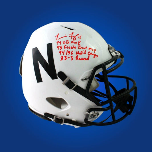Autographed Nebraska Cornhuskers full size Authentic Helmet signed by Tommie Frazier, set against a clean white display background. SportsMarkets memorabilia photo.