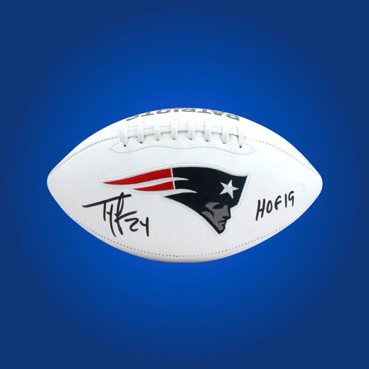 Official football signed by Ty Law, featuring New England Patriots branding and player autograph.