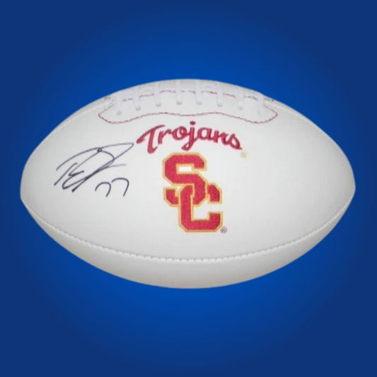 Autographed full size replica football by Tyron Smith, featuring USC Trojans white logo. Certified authentic, a prime collectible for Trojans fans and memorabilia collectors. Certificate of Authenticity included. Ball details may vary for catalog consistency.