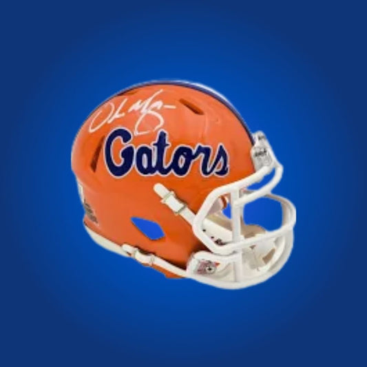 Urban Meyer signed Florida Gators mini helmet, collectible item for college football fans and coaching memorabilia seekers.